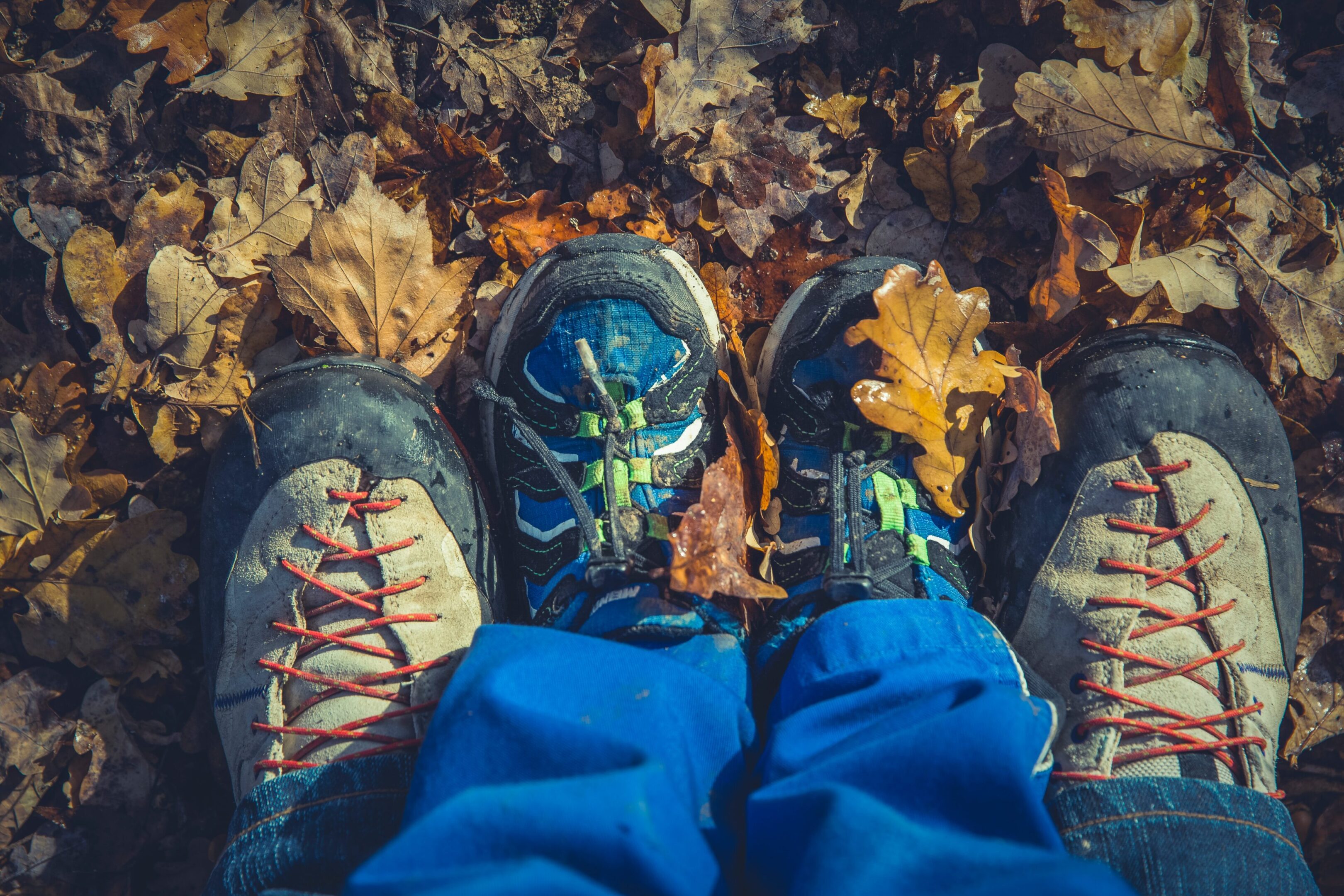 Photo by Markus Spiske on Unsplash A person wearing blue pants and sneakers sitting on the ground.