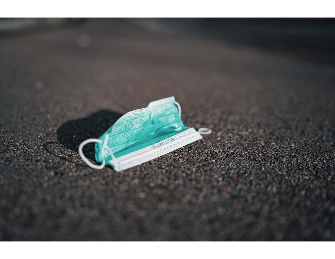 Photo by Claudio Schwarz on Unsplash A blue mask is laying on the ground