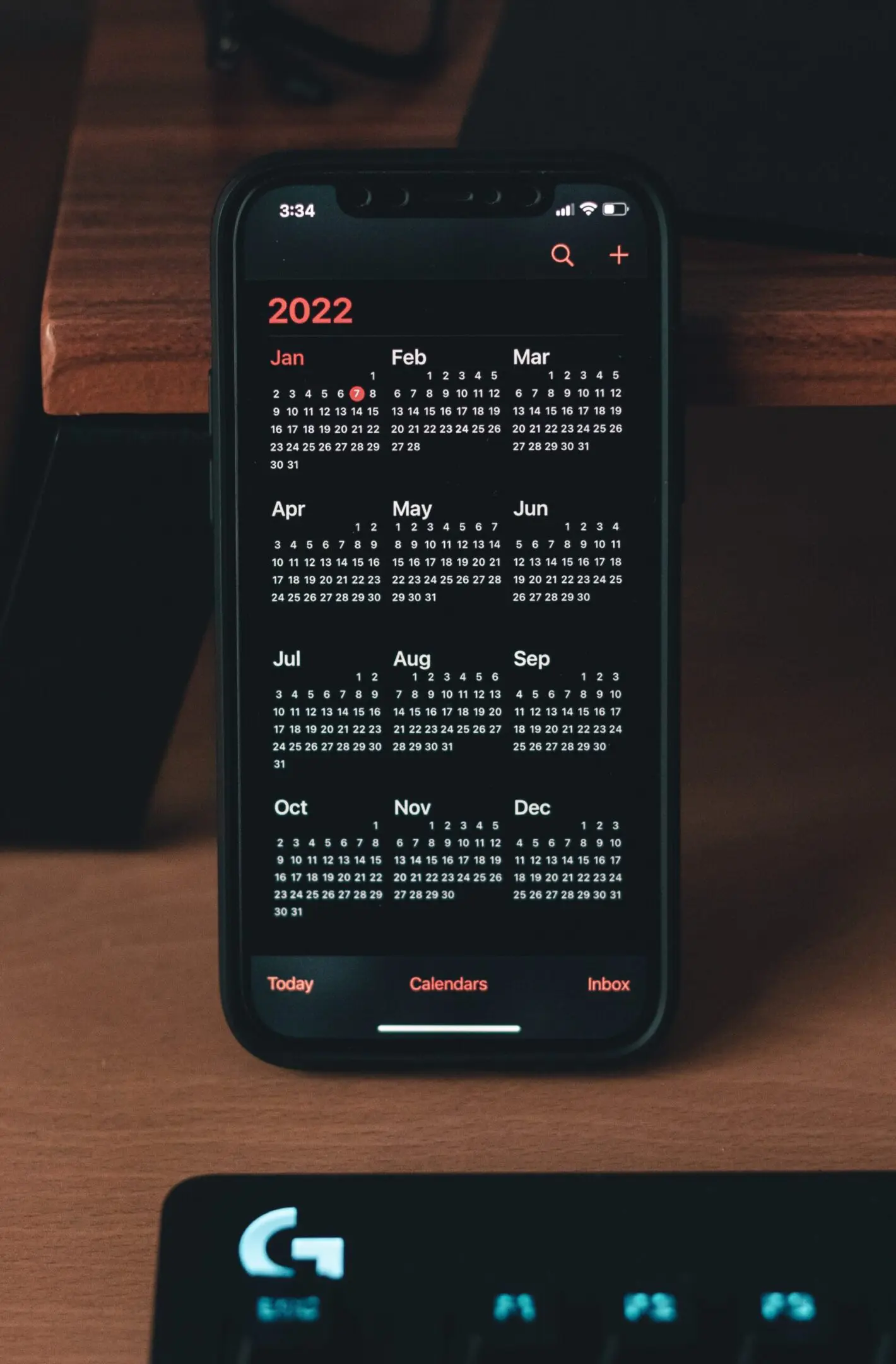 A phone with a calendar on the screen.